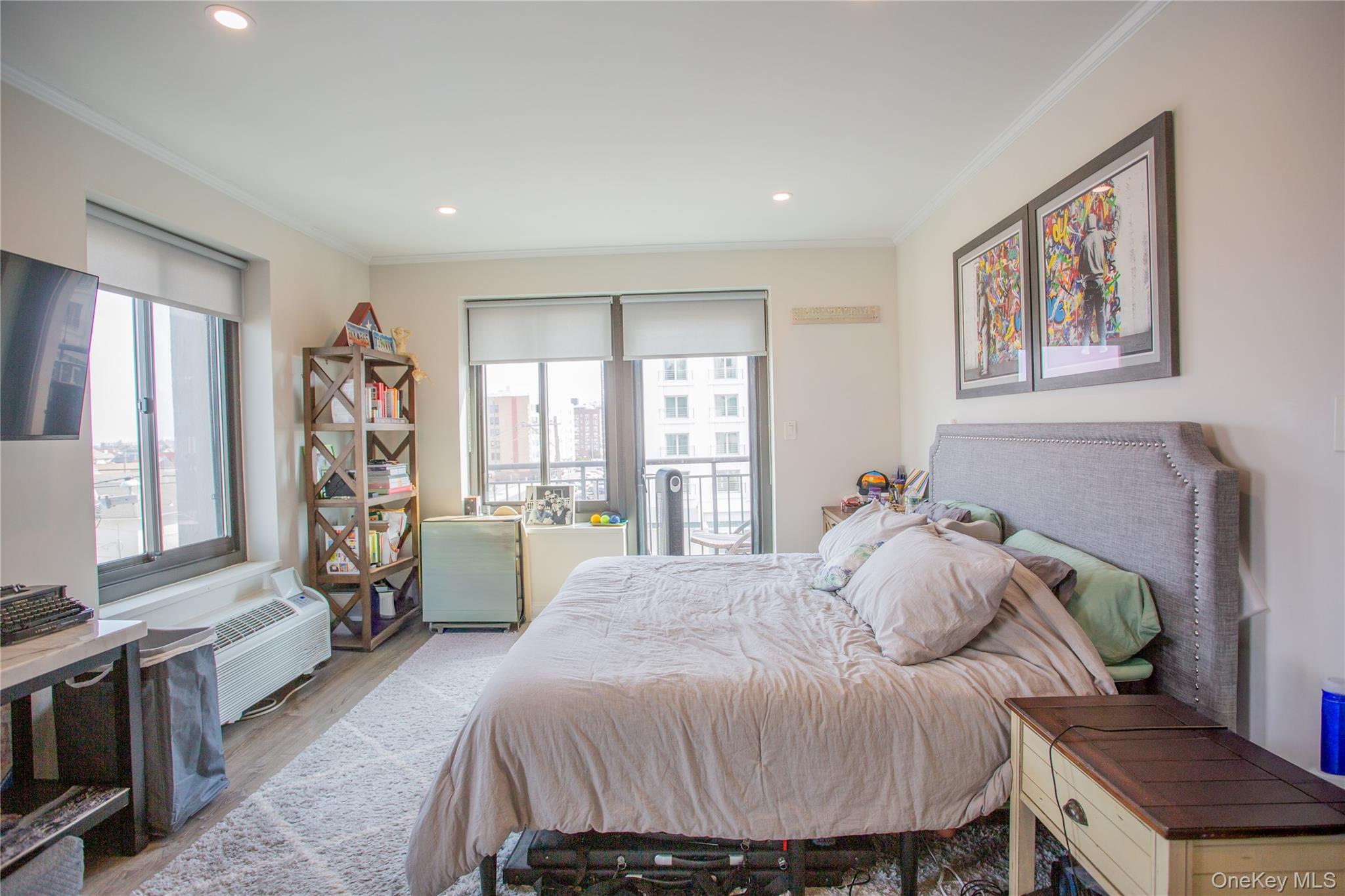 100 West Broadway, Unit 3D Long Beach, NY 11561 - Photo 13 of 50 a bedroom with a bed and wooden floor