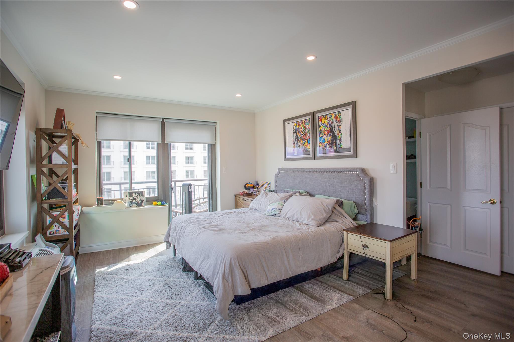 100 West Broadway, Unit 3D Long Beach, NY 11561 - Photo 14 of 50 a bedroom with a bed and a large window