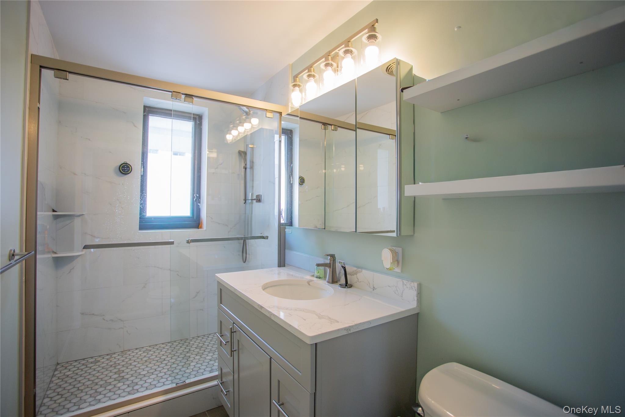 100 West Broadway, Unit 3D Long Beach, NY 11561 - Photo 16 of 50 a bathroom with a sink toilet and shower