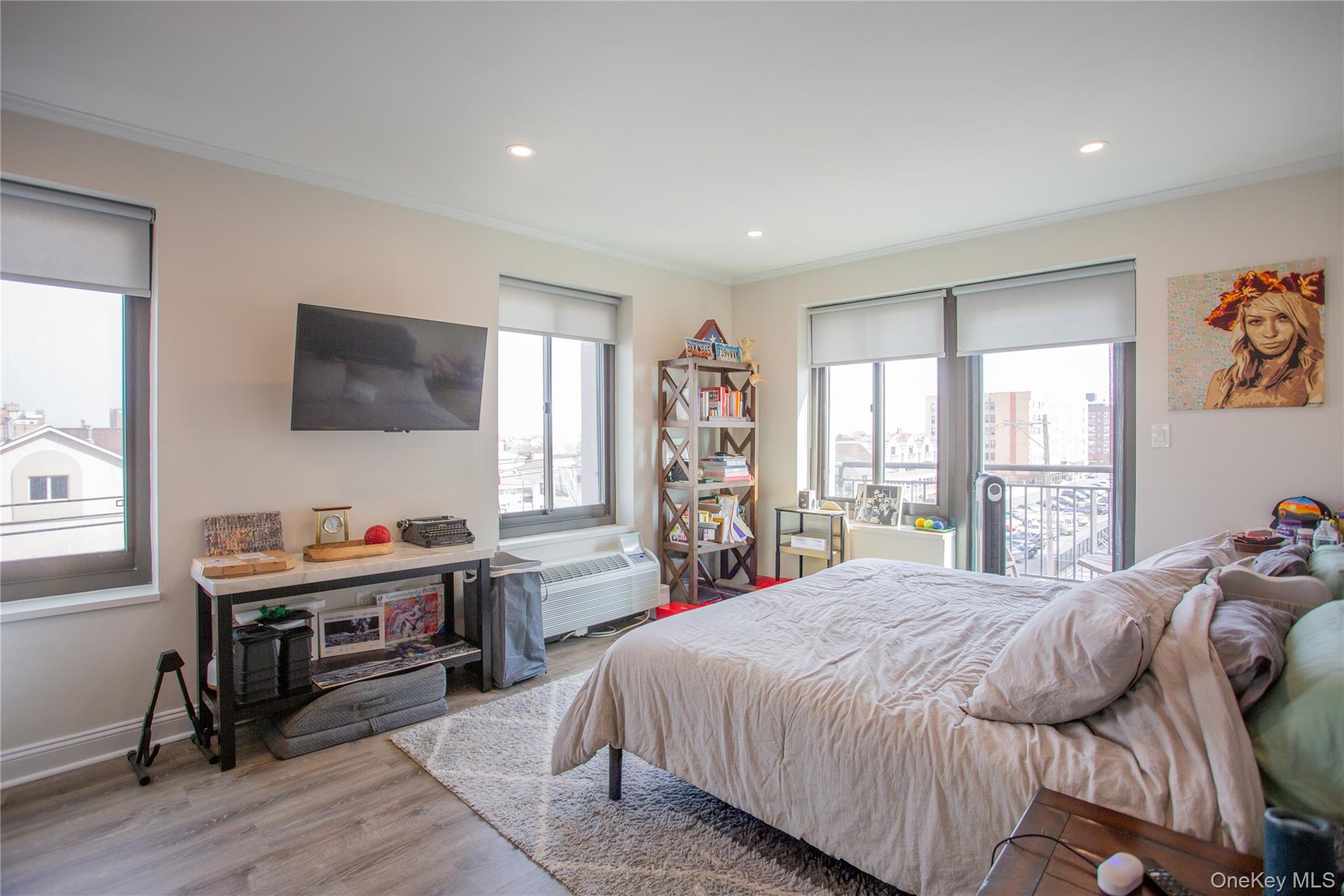 100 West Broadway, Unit 3D Long Beach, NY 11561 - Photo 17 of 50 a bedroom with a bed and a flat screen tv