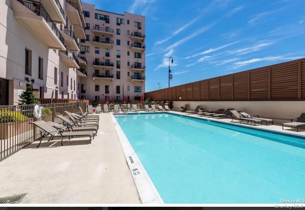 100 West Broadway, Unit 3D Long Beach, NY 11561 - Photo 26 of 50 a view of a swimming pool with outdoor seating