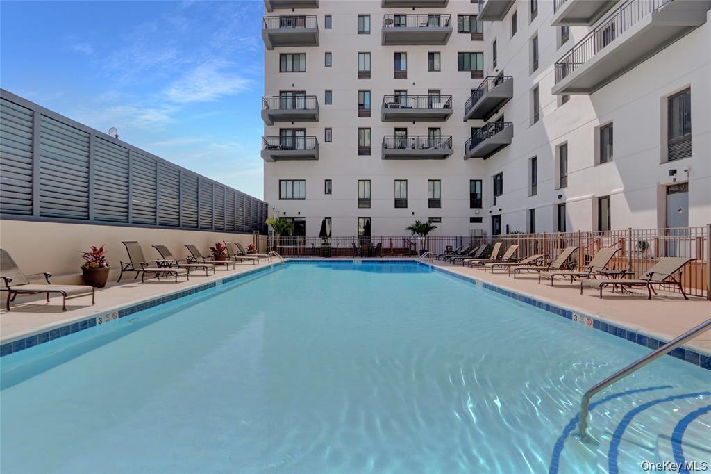 100 West Broadway, Unit 3D Long Beach, NY 11561 - Photo 28 of 50 a large building with swimming pool in front of it