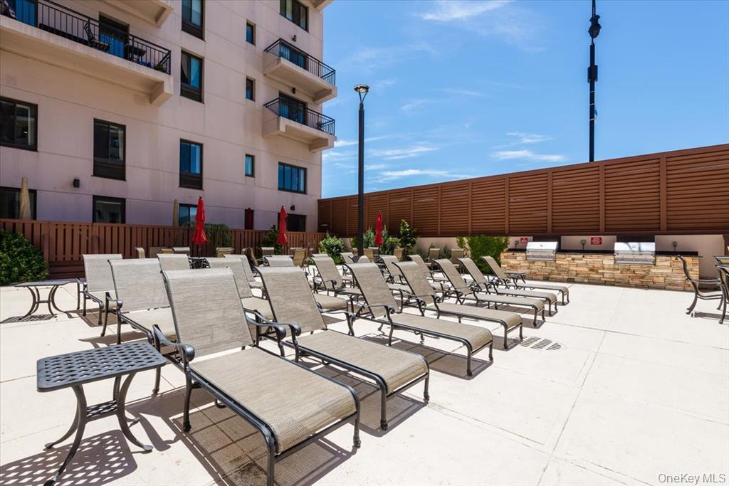 100 West Broadway, Unit 3D Long Beach, NY 11561 - Photo 29 of 50 a view of a patio with chairs and tables