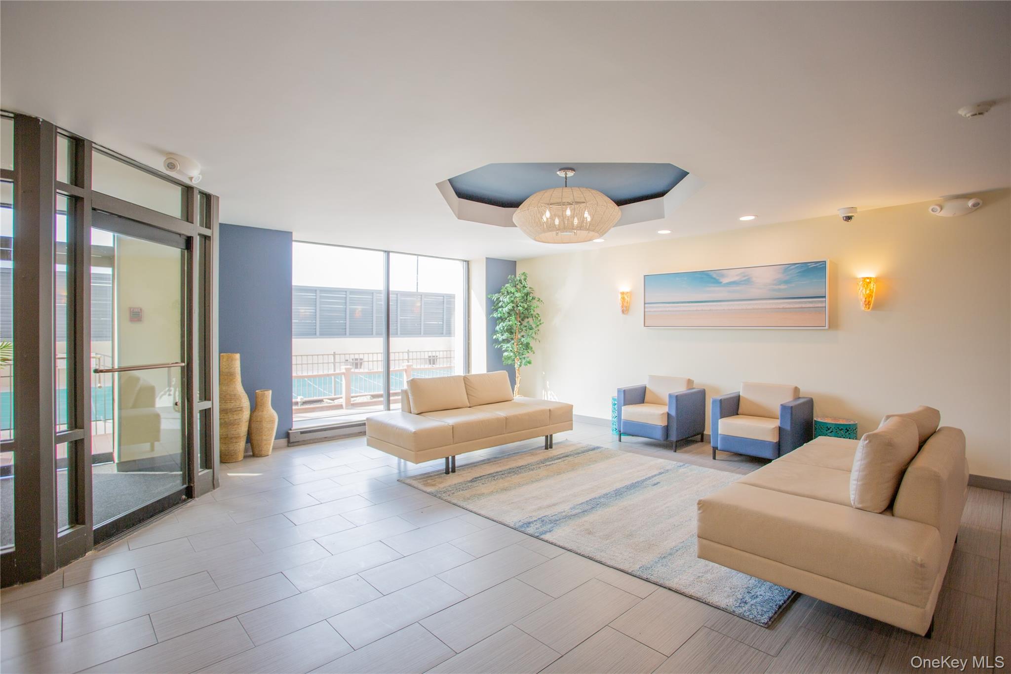 100 West Broadway, Unit 3D Long Beach, NY 11561 - Photo 32 of 50 a living room with furniture and a large window