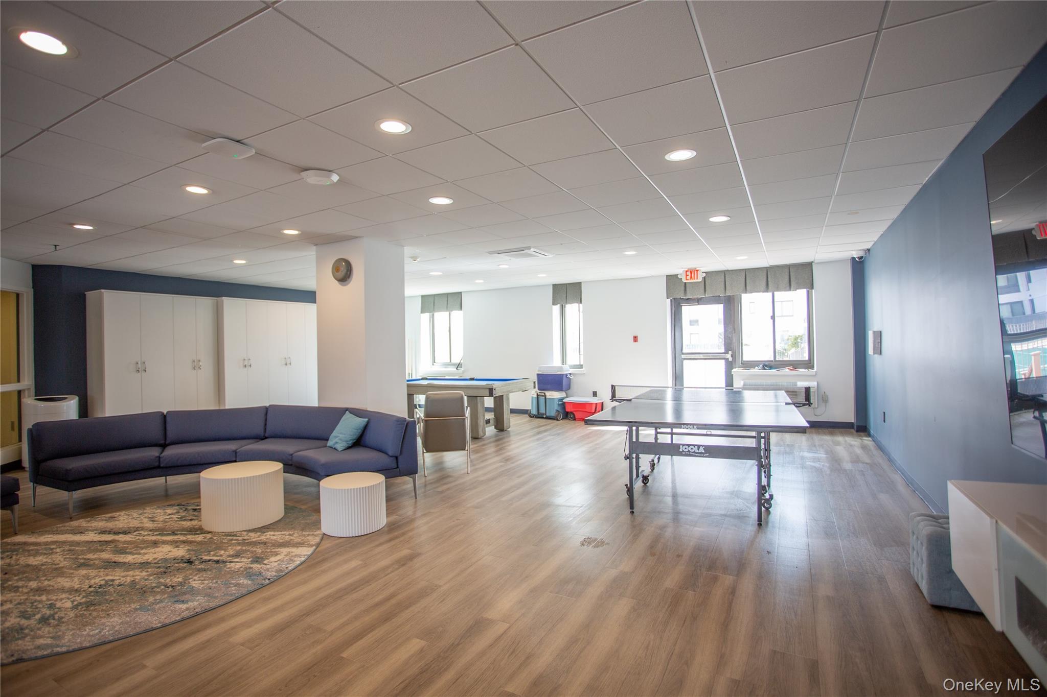 100 West Broadway, Unit 3D Long Beach, NY 11561 - Photo 37 of 50 a living room with furniture and a wooden floor
