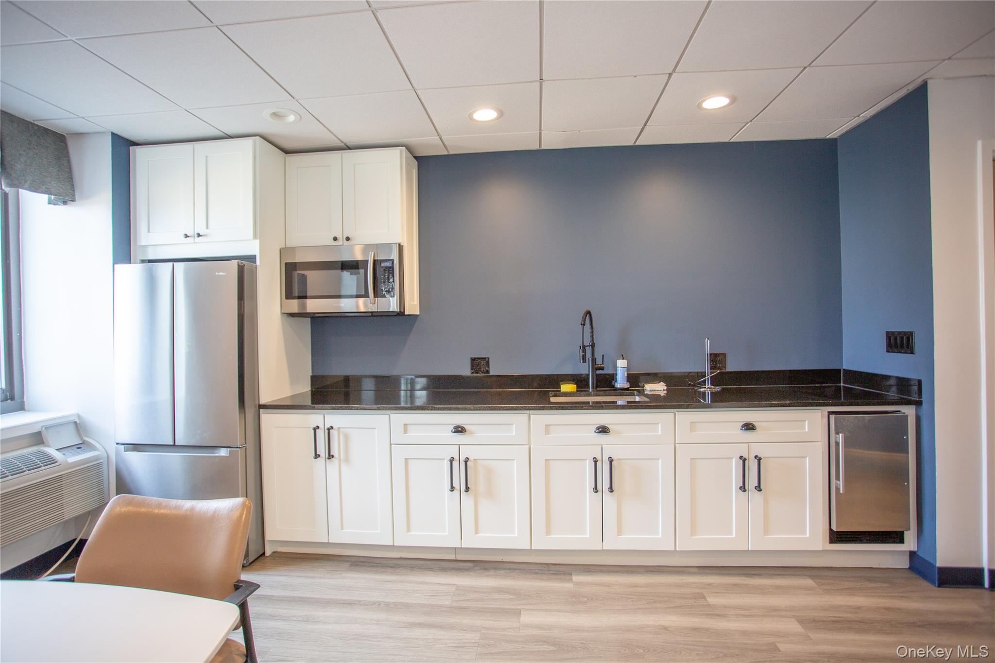 100 West Broadway, Unit 3D Long Beach, NY 11561 - Photo 39 of 50 a kitchen with granite countertop a stove a sink and a refrigerator
