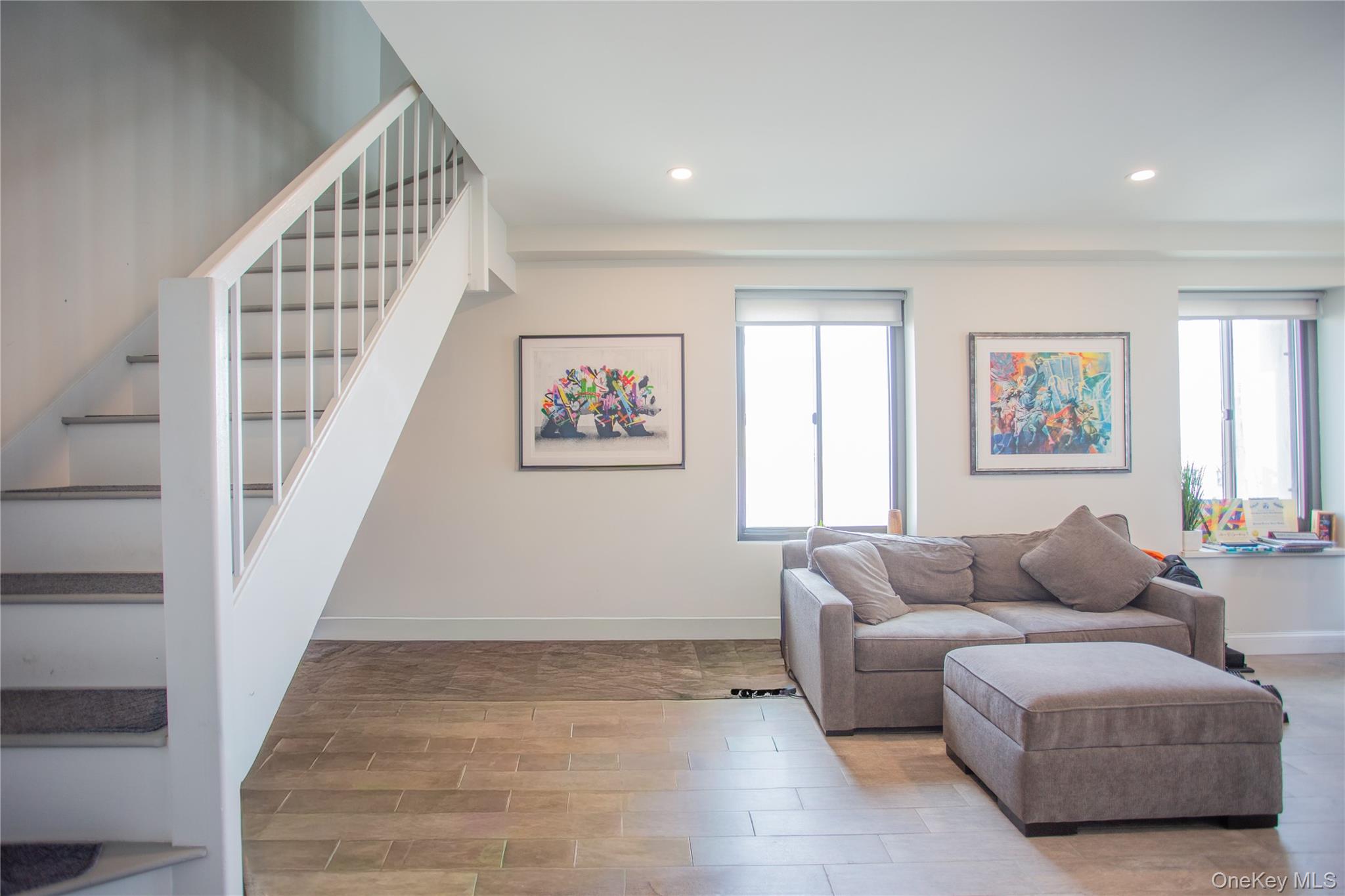 100 West Broadway, Unit 3D Long Beach, NY 11561 - Photo 4 of 50 a living room with furniture and a stairs