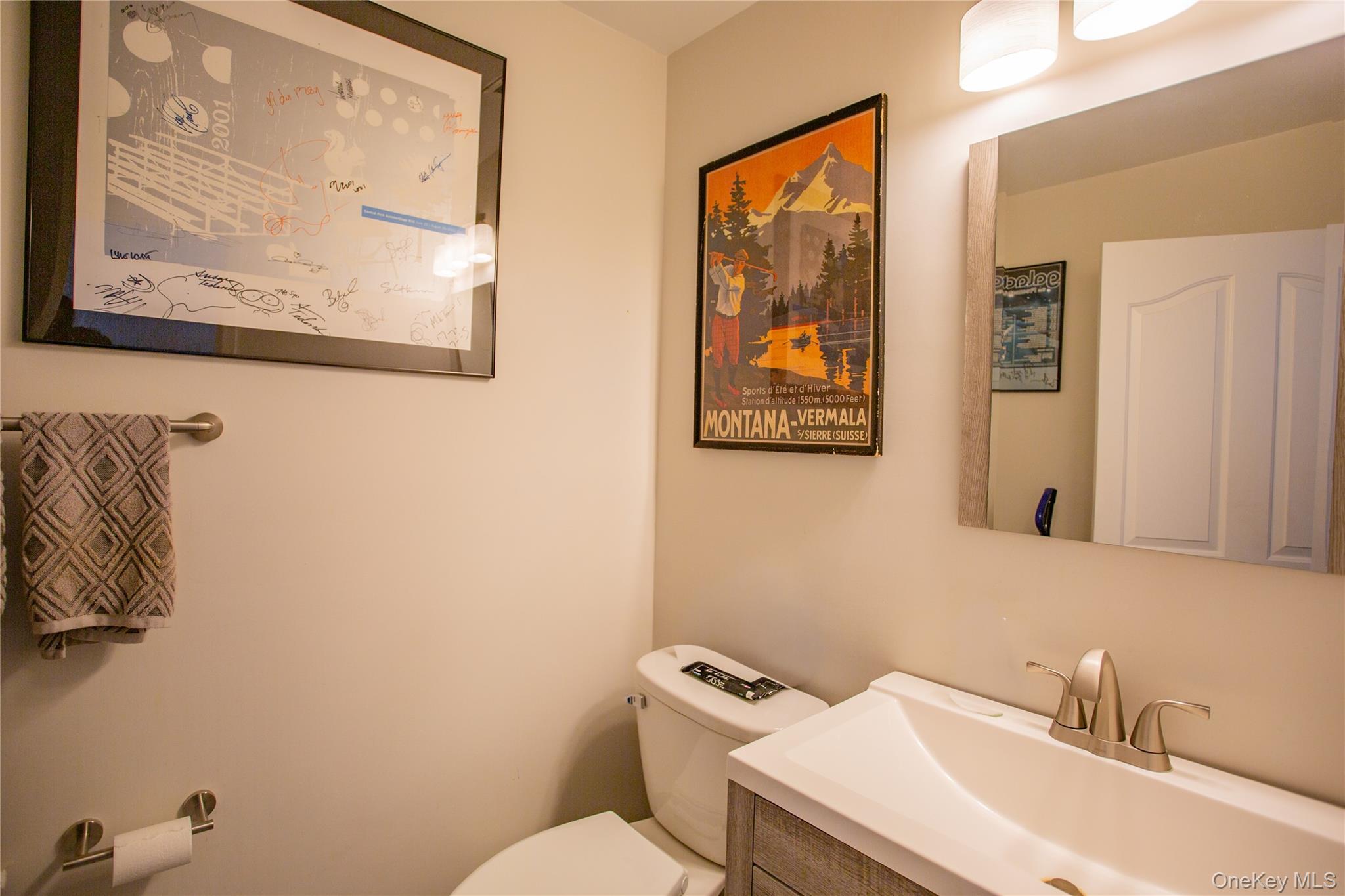 100 West Broadway, Unit 3D Long Beach, NY 11561 - Photo 6 of 50 a bathroom with a toilet sink and mirror