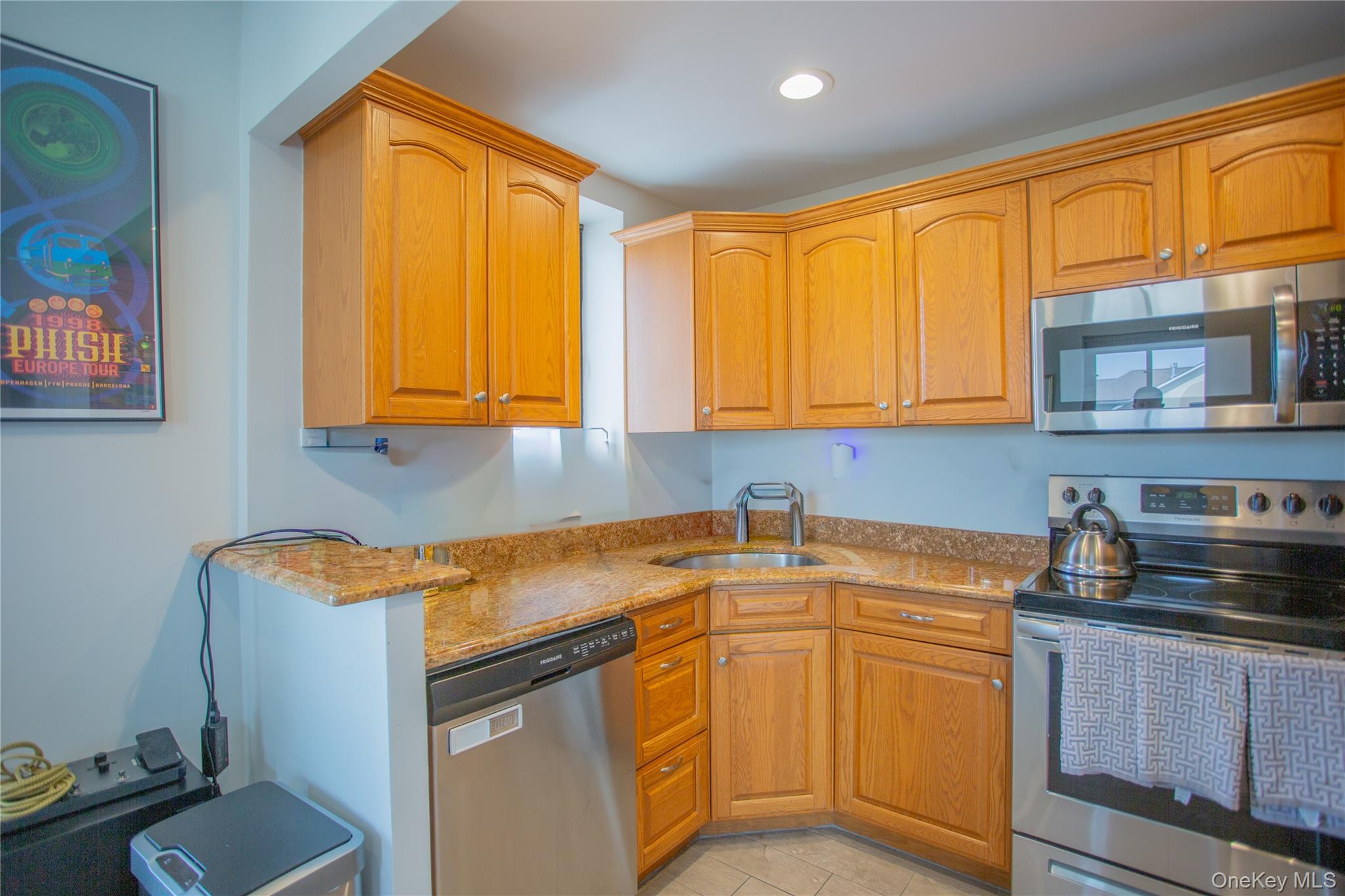 100 West Broadway, Unit 3D Long Beach, NY 11561 - Photo 7 of 50 a kitchen with stainless steel appliances granite countertop a sink stove and cabinets