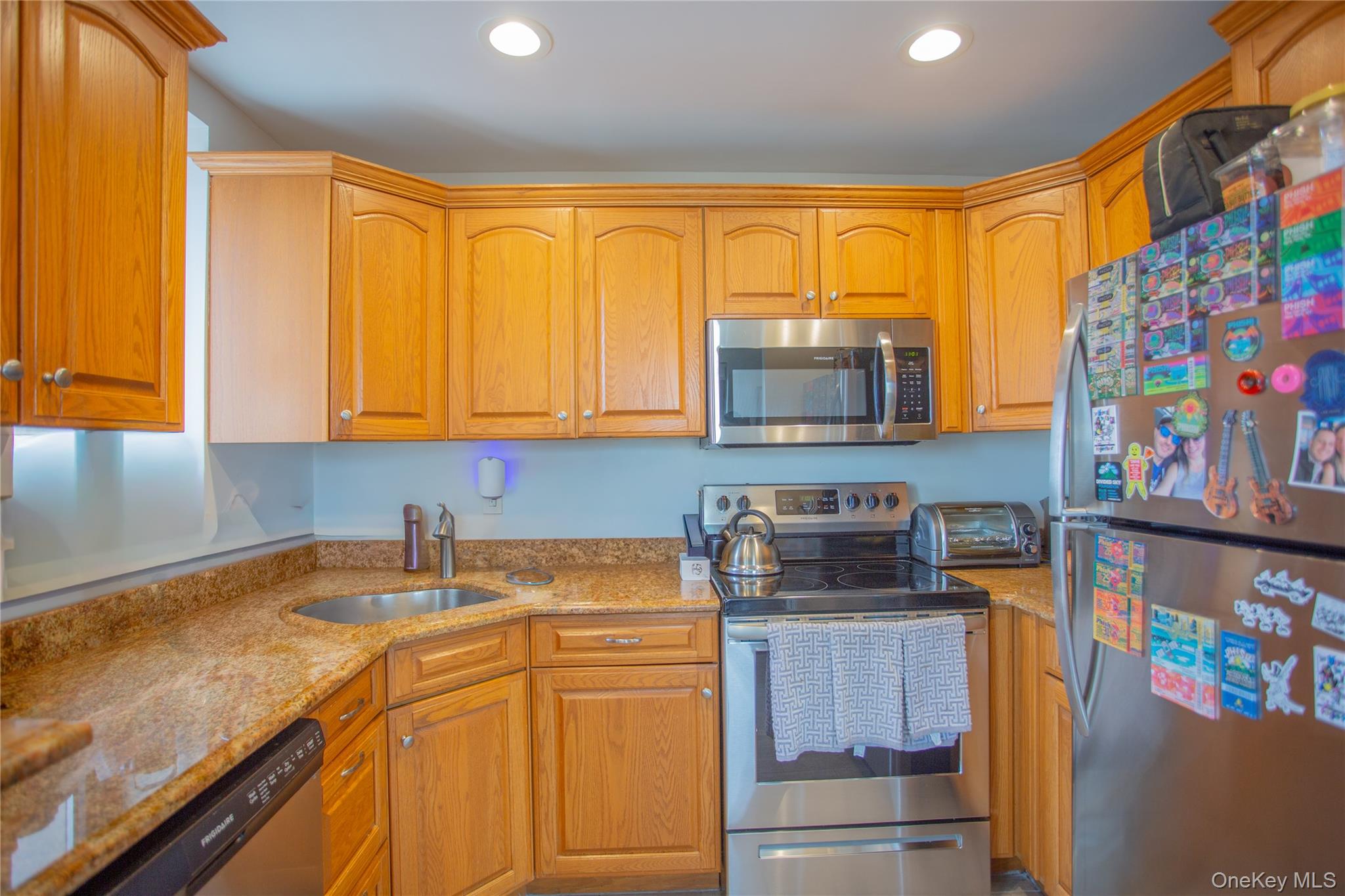 100 West Broadway, Unit 3D Long Beach, NY 11561 - Photo 8 of 50 a kitchen with stainless steel appliances granite countertop a stove a sink and a microwave