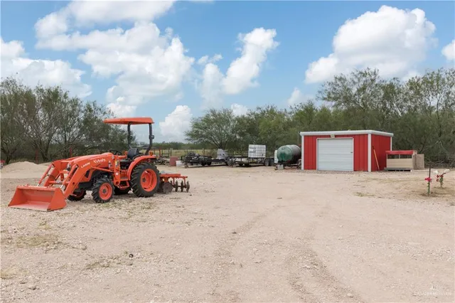 a view of a backyard with furniture and a floor to ceiling window