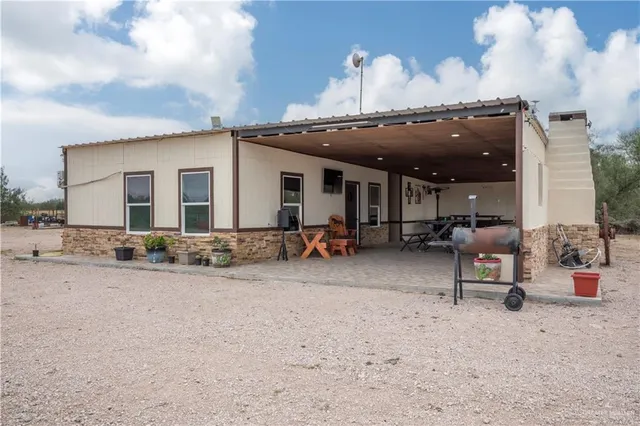 a kitchen with a table chairs and wooden floor
