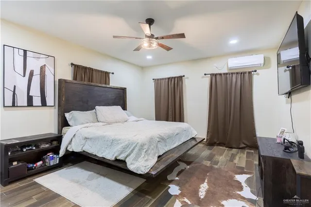 a bathroom with a granite countertop sink a toilet and a mirror
