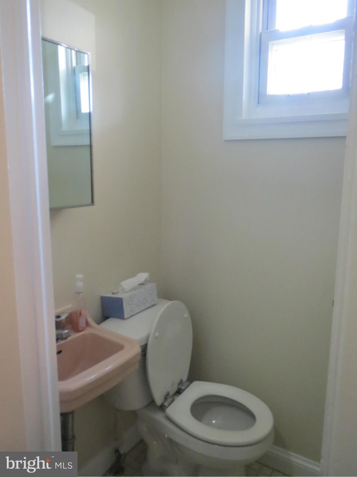 7006 Boxford Road Baltimore, MD 21215 - Photo 8 of 14 a white toilet sitting next to a bathroom sink