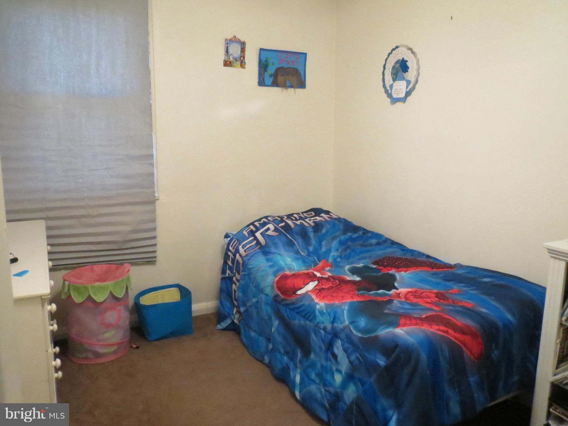 7006 Boxford Road Baltimore, MD 21215 - Photo 9 of 14 a bedroom with a bed and a painting on the wall