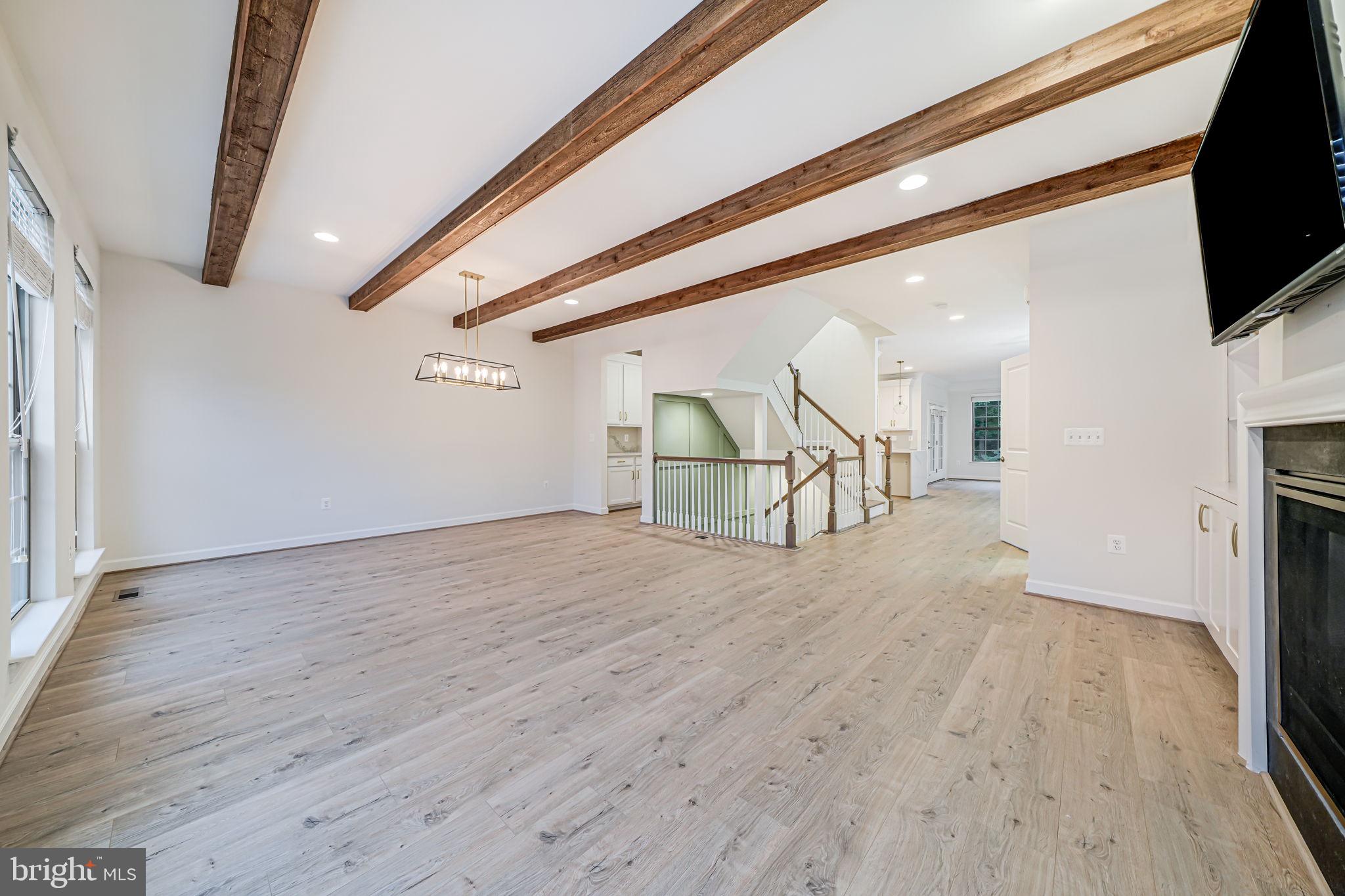 7917 Turtle Creek Circle Gainesville, VA 20155 - Photo 12 of 41 a view of a livingroom with wooden floor and a flat screen tv