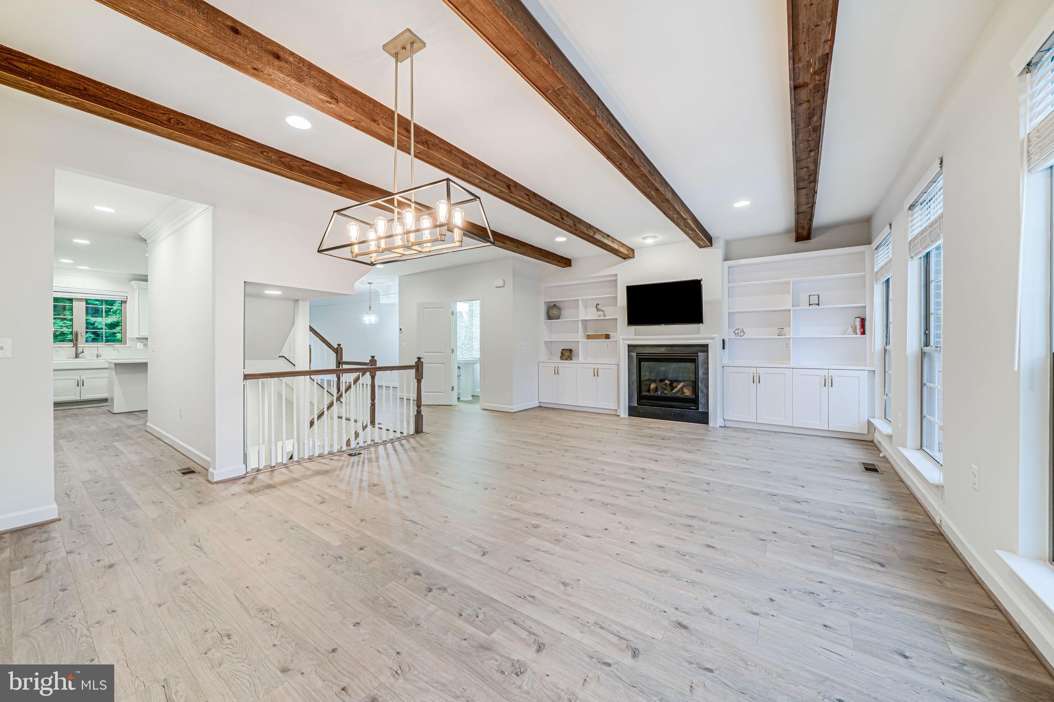 7917 Turtle Creek Circle Gainesville, VA 20155 - Photo 13 of 41 a view of a livingroom with a flat screen tv staircase and a kitchen