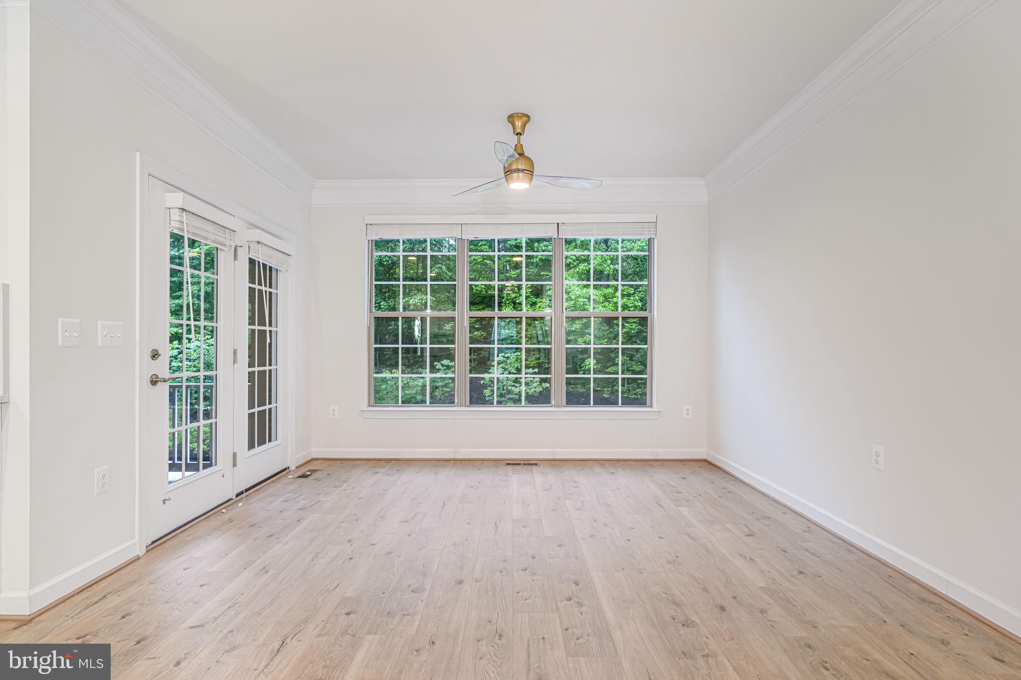 7917 Turtle Creek Circle Gainesville, VA 20155 - Photo 17 of 41 a view of an empty room with wooden floor and a window