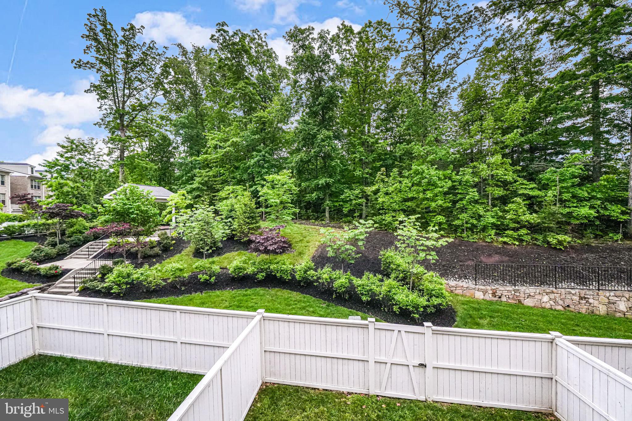 7917 Turtle Creek Circle Gainesville, VA 20155 - Photo 19 of 41 a view of a yard with plants and wooden fence