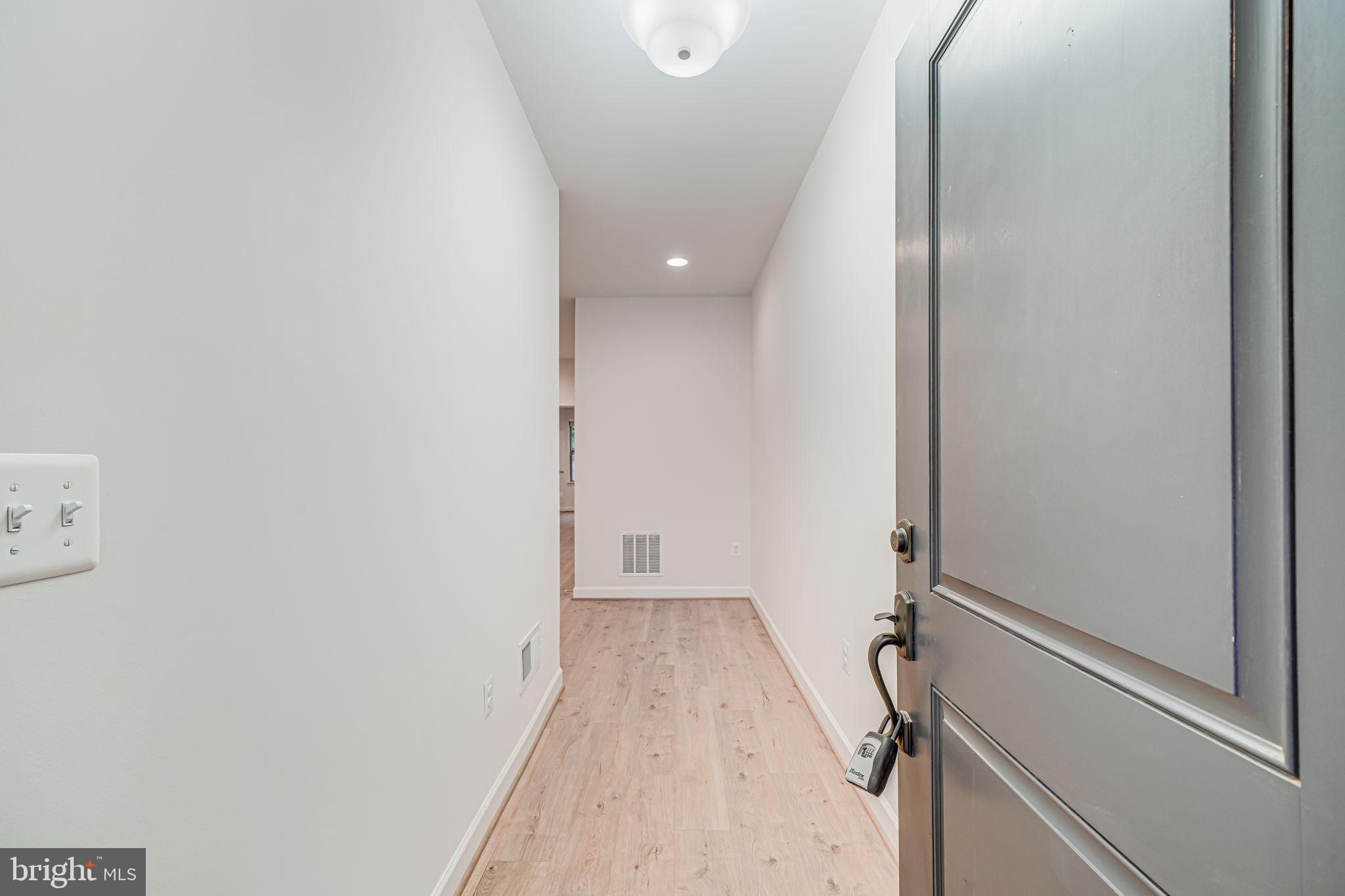 7917 Turtle Creek Circle Gainesville, VA 20155 - Photo 3 of 41 a view of a room with wooden floor and mirror