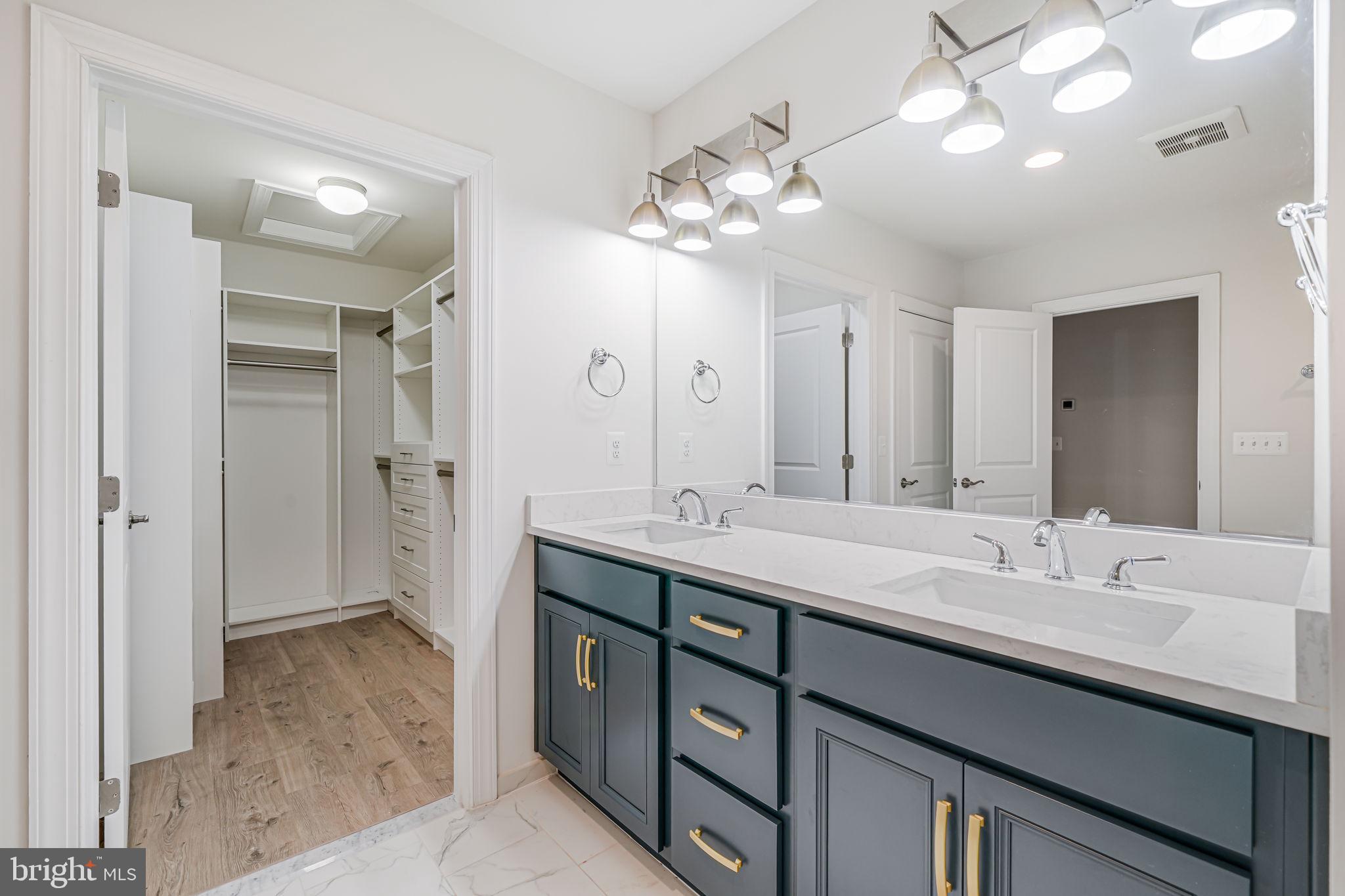 7917 Turtle Creek Circle Gainesville, VA 20155 - Photo 34 of 41 a bathroom with a double vanity sink mirror and shower
