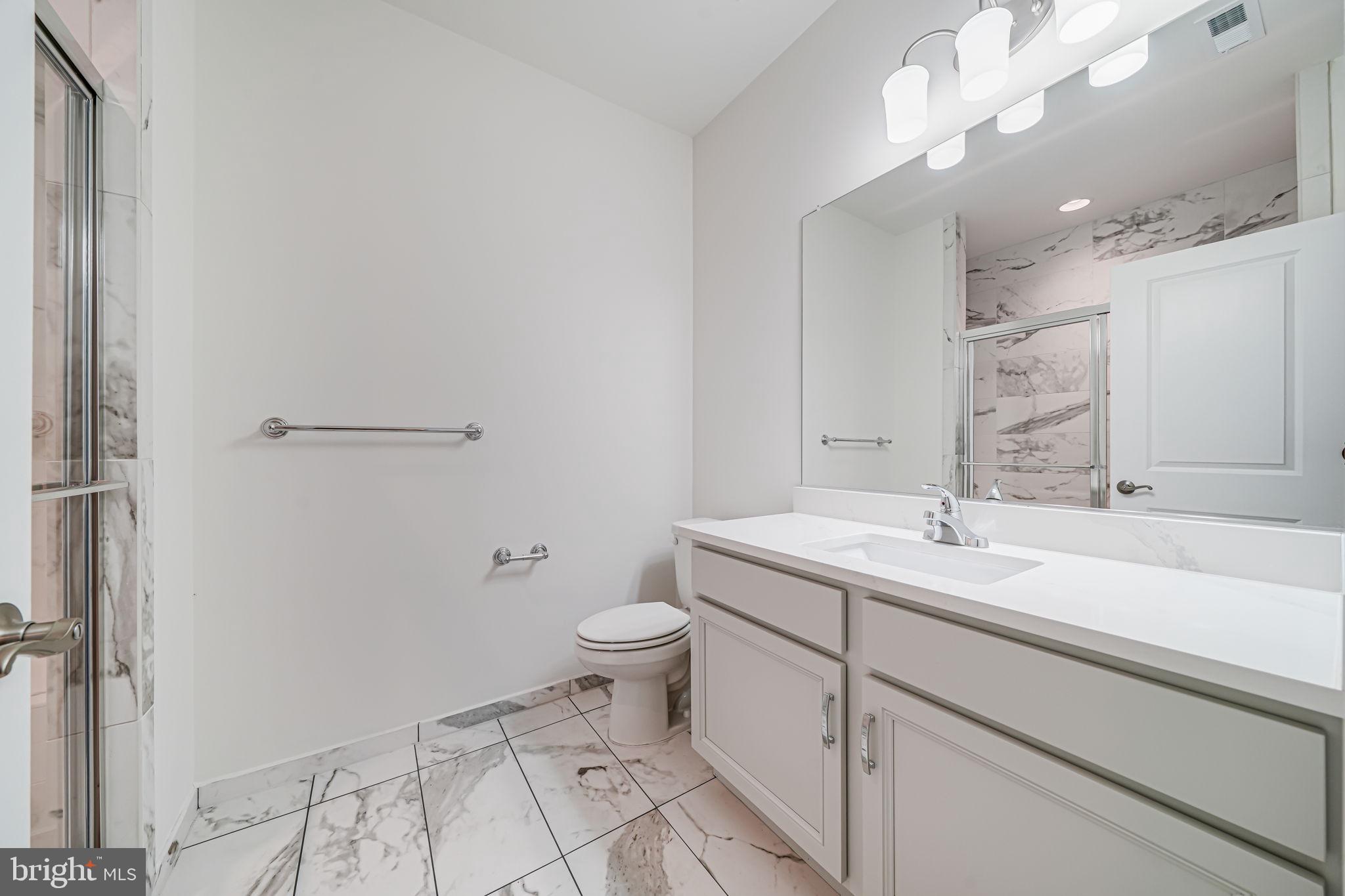 7917 Turtle Creek Circle Gainesville, VA 20155 - Photo 6 of 41 a bathroom with a sink a toilet a mirror and vanity