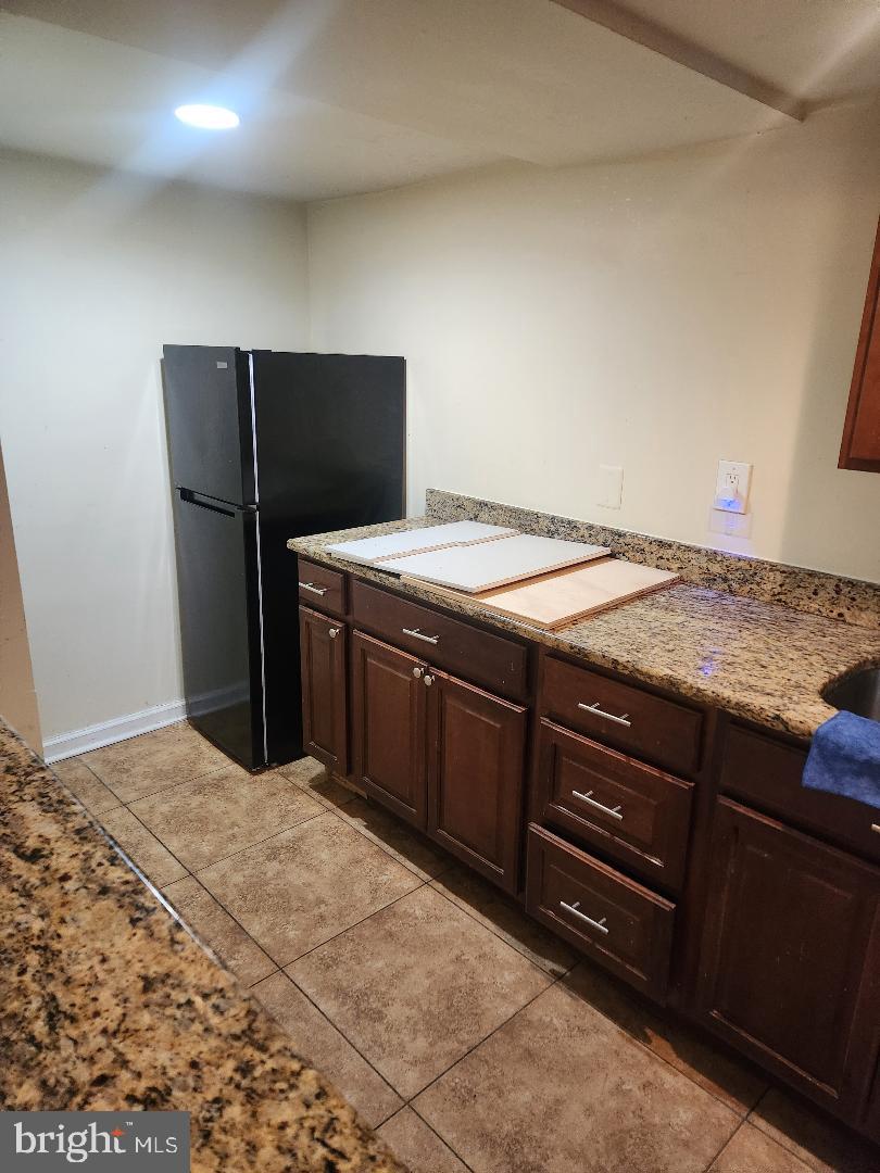 1011 Nova Avenue Capitol Heights, MD 20743 - Photo 14 of 15 a kitchen with a stove and a refrigerator