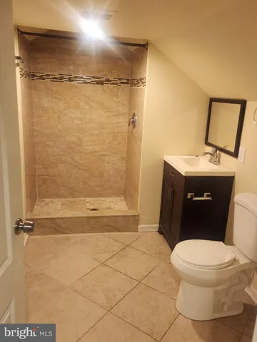 a bathroom with a granite countertop toilet sink and shower