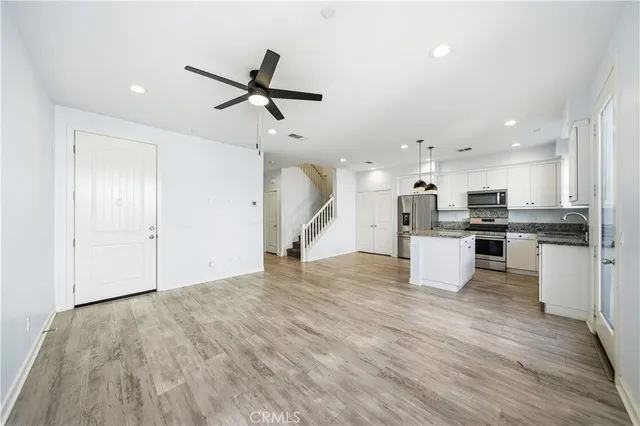 a view of a kitchen with microwave and cabinets