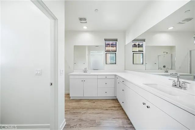 a spacious bathroom with a granite countertop sink mirror and a