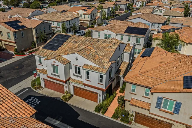 an aerial view of a residential apartment building with a yard
