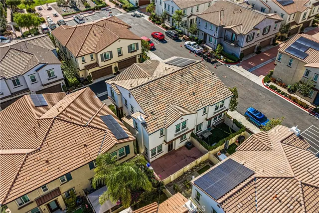 an aerial view of a house with a yard