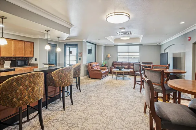 a living room with furniture a dining table and chairs