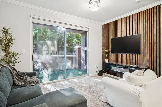 a living room with furniture tv and a window