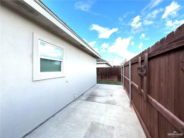 a view of a backyard with wooden fence
