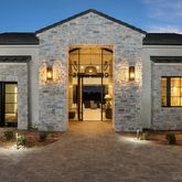 front view of a brick house with a large window