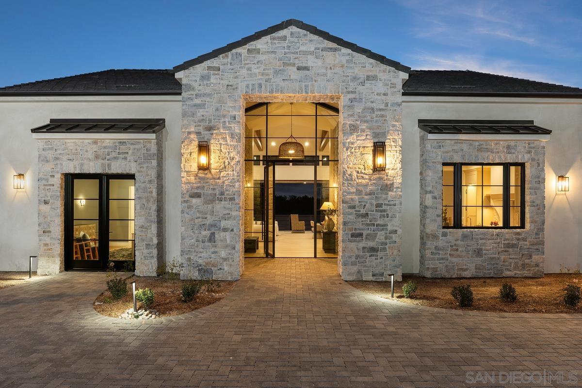 6691 Camino Saucito Rancho Santa Fe, CA 92067 - Photo 1 of 54 front view of a brick house with a large window