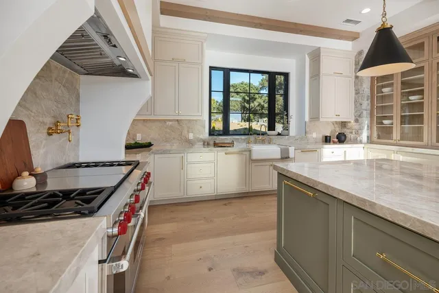 a kitchen with stainless steel appliances granite countertop a sink stove and cabinets