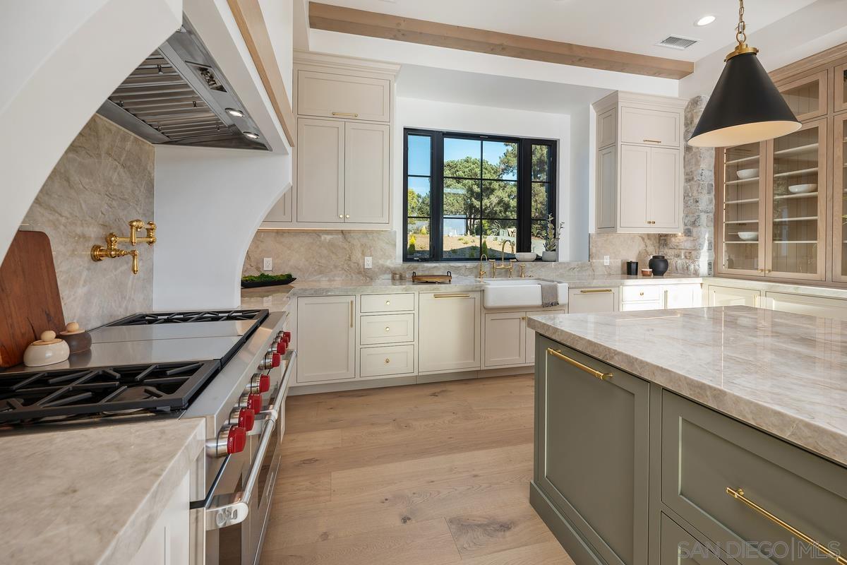 6691 Camino Saucito Rancho Santa Fe, CA 92067 - Photo 11 of 54 a kitchen with stainless steel appliances granite countertop a sink stove and cabinets
