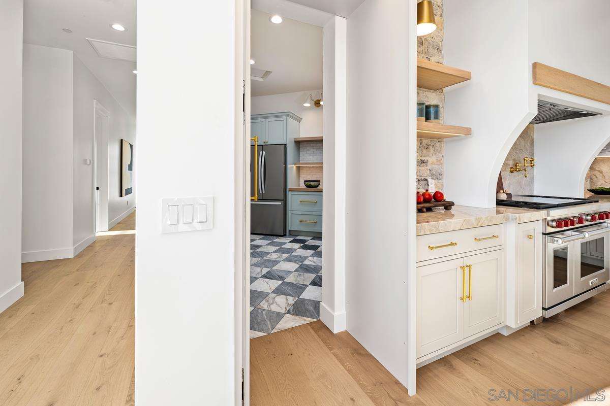 6691 Camino Saucito Rancho Santa Fe, CA 92067 - Photo 13 of 54 a kitchen with cabinets and a stove