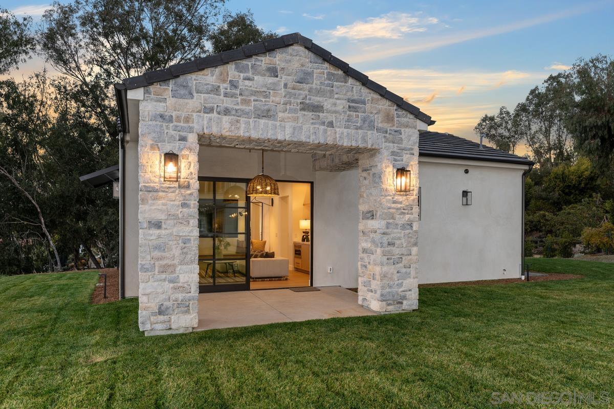 6691 Camino Saucito Rancho Santa Fe, CA 92067 - Photo 16 of 55 a front view of a house with garden