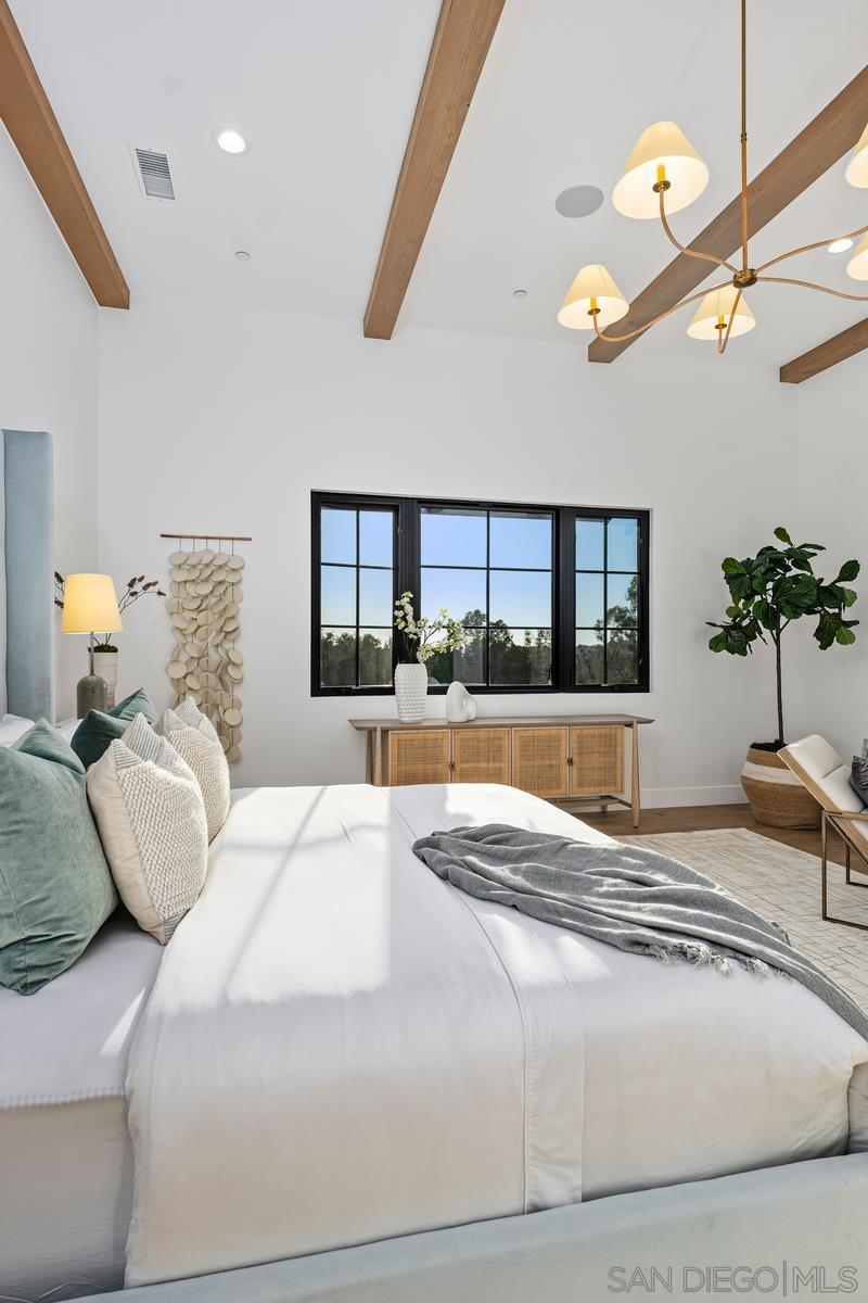 6691 Camino Saucito Rancho Santa Fe, CA 92067 - Photo 22 of 54 a spacious bedroom with a large bed and a large window