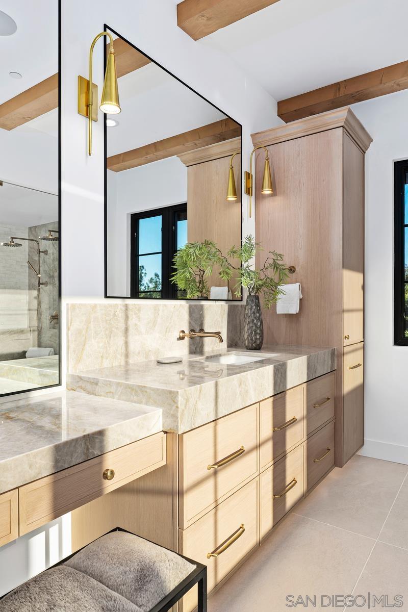 6691 Camino Saucito Rancho Santa Fe, CA 92067 - Photo 23 of 55 a bathroom with a double vanity sink and a mirror