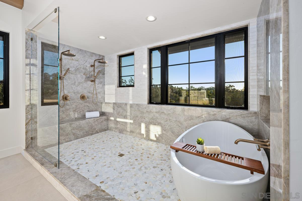6691 Camino Saucito Rancho Santa Fe, CA 92067 - Photo 24 of 55 a bathroom with a bathtub sink and a shower