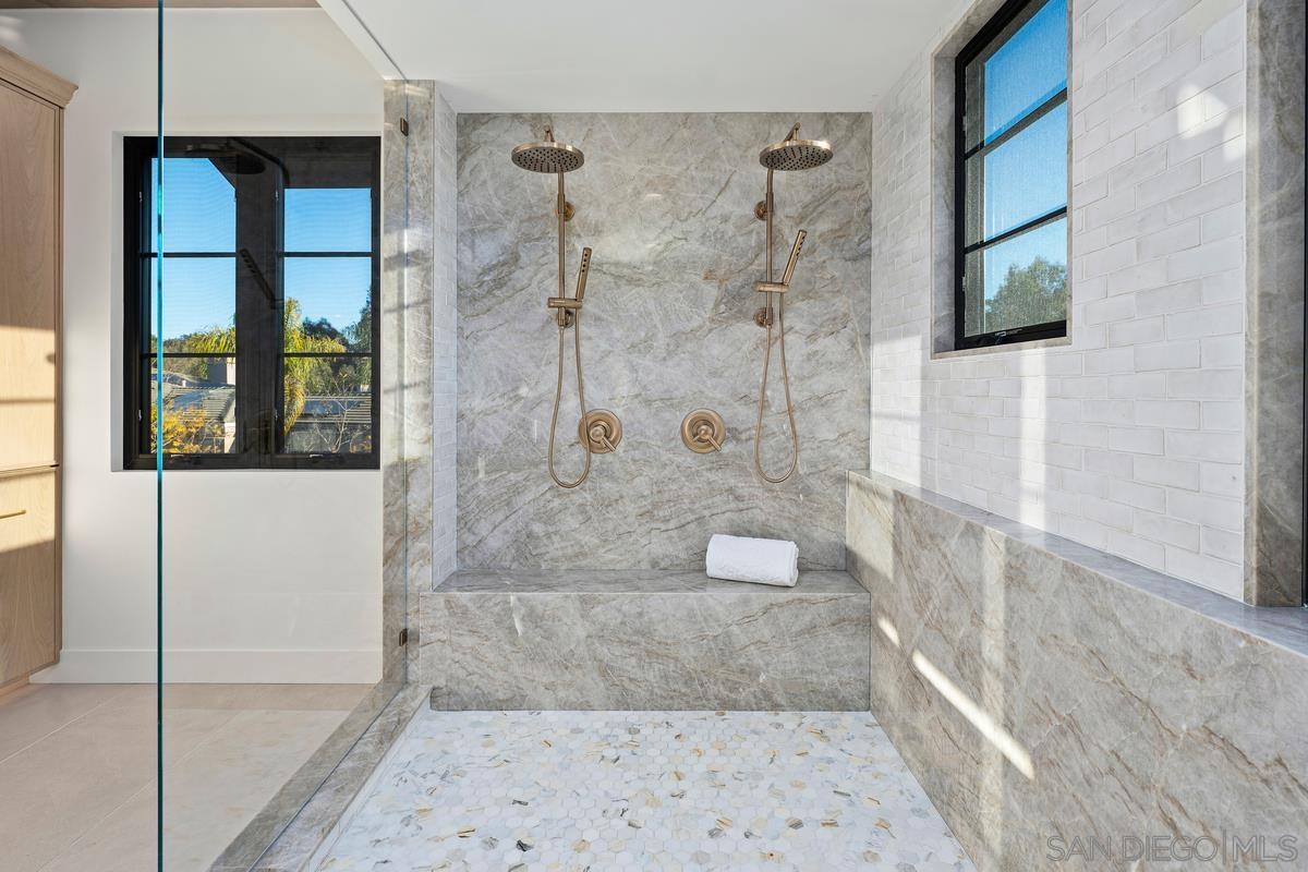 6691 Camino Saucito Rancho Santa Fe, CA 92067 - Photo 25 of 54 a bathroom with a glass shower door