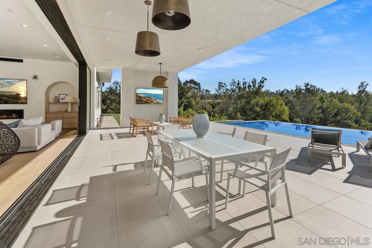 6691 Camino Saucito Rancho Santa Fe, CA 92067 - Photo 29 of 54 a view of a dining room with furniture and wooden floor