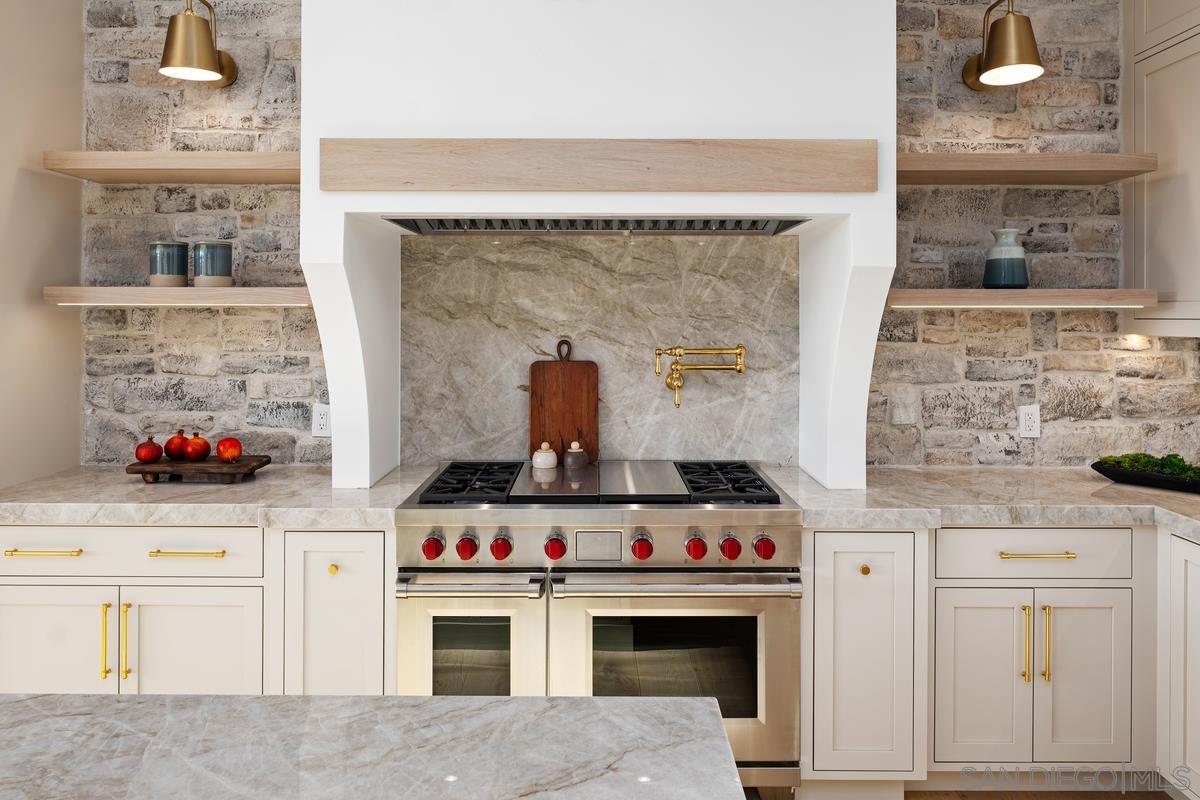 6691 Camino Saucito Rancho Santa Fe, CA 92067 - Photo 31 of 55 a stove top oven sitting inside of a kitchen