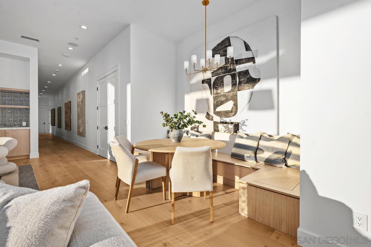 6691 Camino Saucito Rancho Santa Fe, CA 92067 - Photo 34 of 54 a view of a dining room with furniture and wooden floor