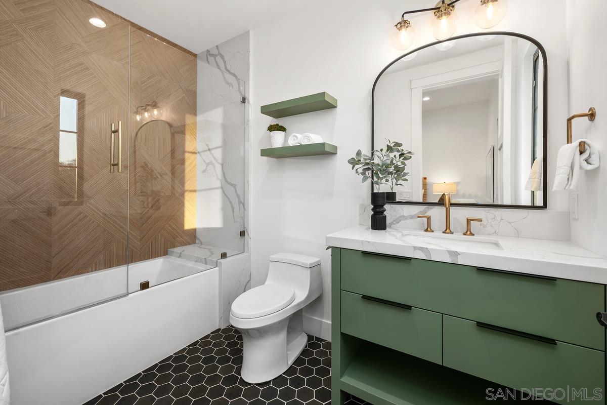 6691 Camino Saucito Rancho Santa Fe, CA 92067 - Photo 37 of 54 a bathroom with a toilet sink and mirror