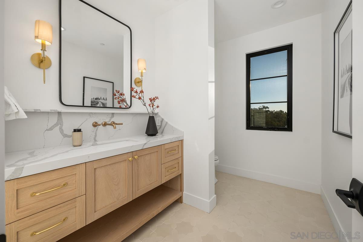 6691 Camino Saucito Rancho Santa Fe, CA 92067 - Photo 38 of 55 a bathroom with a sink and a mirror